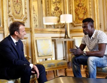 French President Emmanuel Macron (L) meets with Mamoudou Gassama, 22, from Mali, at the Elysee Palace in Paris, France, May 28, 2018. Mamoudou Gassama living illegally in France is being honored by Macron for scaling an apartment building over the weekend to save a 4-year-old child dangling from a fifth-floor balcony. Thibault Camus/Pool via Reuters - RC17E8529380