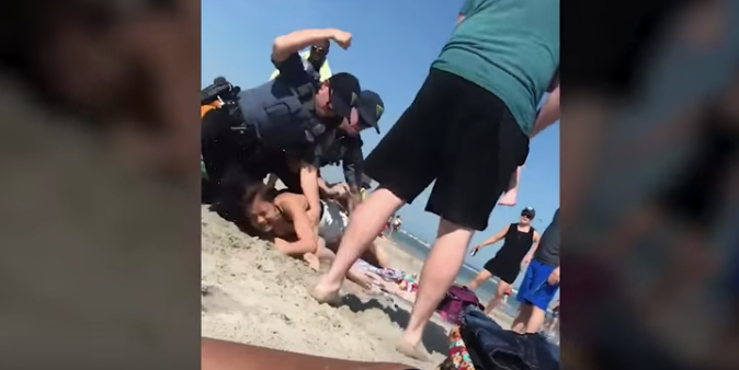 Screenshot of the YouTube video showing Wildwood Police striking the woman before officers handcuffed her. (YouTube)