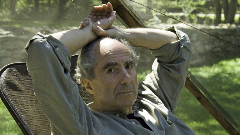 Famed novelist Philip Roth sits inside a screened tent at his home on Sept. 5, 2005, in Warren, Conn. Roth died on Tuesday. He was 85. (Douglas Healey/AP)