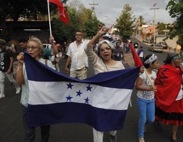 Members of the opposition to the administration of Honduran President Juan Orlando Hernandez march on Friday to protest the U.S. government's decision to end the Temporary Protected Status designation for nearly 57,000 people from Honduras. Hernandez called the decision a sovereign issue for Washington, adding that 