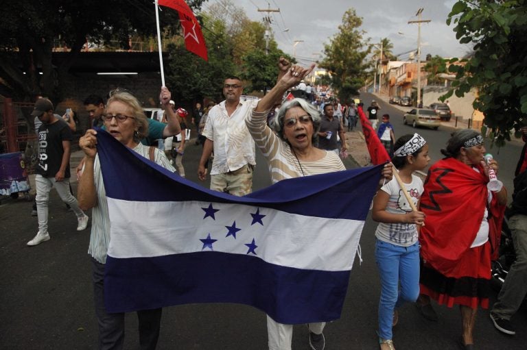 Members of the opposition to the administration of Honduran President Juan Orlando Hernandez march on Friday to protest the U.S. government's decision to end the Temporary Protected Status designation for nearly 57,000 people from Honduras. Hernandez called the decision a sovereign issue for Washington, adding that 