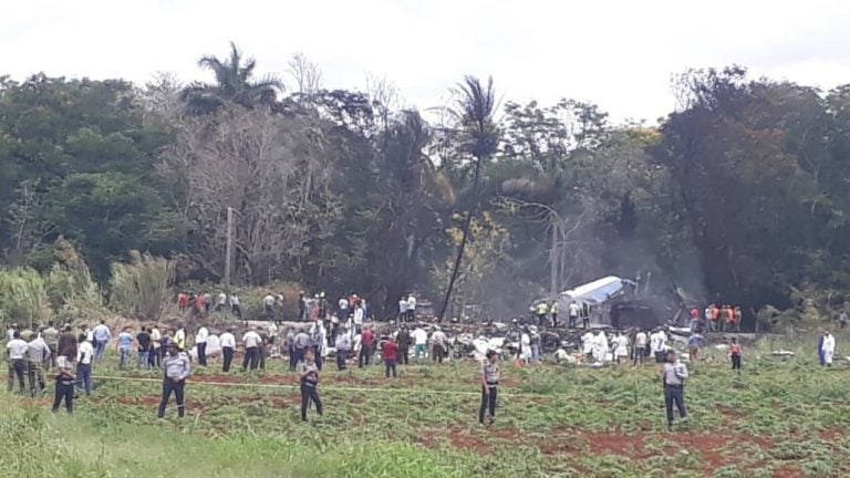 First responders and law enforcement gather in the field where an airliner crashed after takeoff Friday, just outside the international airport in Havana, Cuba. (Andrea Rodriguez/AP)