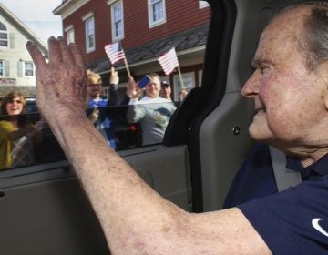 In this May 20 photo provided by the office of George H.W. Bush, the former president waves to supporters as his motorcade arrives in Kennebunkport, Maine. A Bush spokesman said the nation's 41st president was eager to get to Maine after enduring his wife's death and then being hospitalized shortly after that with a blood infection.
