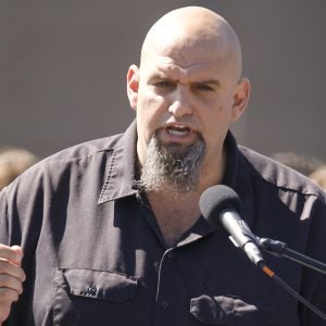 John Fetterman, the mayor of Braddock, Pa. addresses a crowd on the roof of his home during his announcement that he is running for the U.S. Senate on Monday, Sept. 14, 2015 in Braddock, Pa.