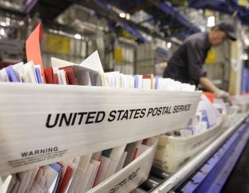 A Chicago man has been charged with mail fraud and mail theft after allegedly changing UPS's corporate mailing address to the address of his own apartment. Here, mail is sorted at Chicago's main post office in 2006. (Scott Olson/Getty Images)