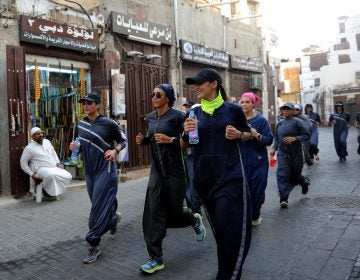 Saudi women jog in the streets of Jeddah in March. The government is encouraging greater participation by women in sports. (Amer Hilabi/AFP/Getty Images)