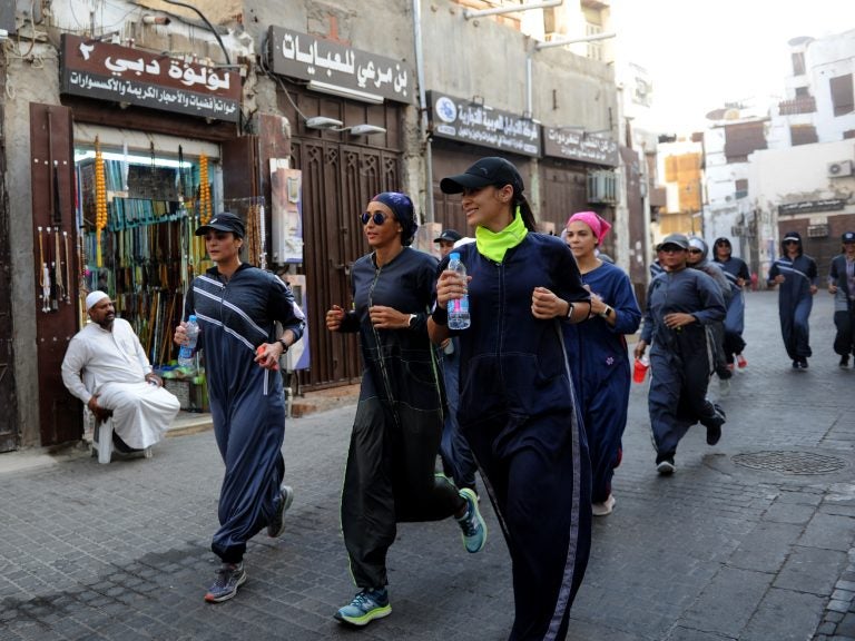 Saudi women jog in the streets of Jeddah in March. The government is encouraging greater participation by women in sports. (Amer Hilabi/AFP/Getty Images)