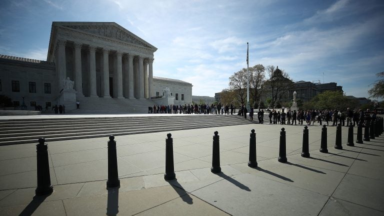 People wait in line to enter the U.S. Supreme Court last month. The court sided with businesses not allowing class-action lawsuits for federal labor violations.