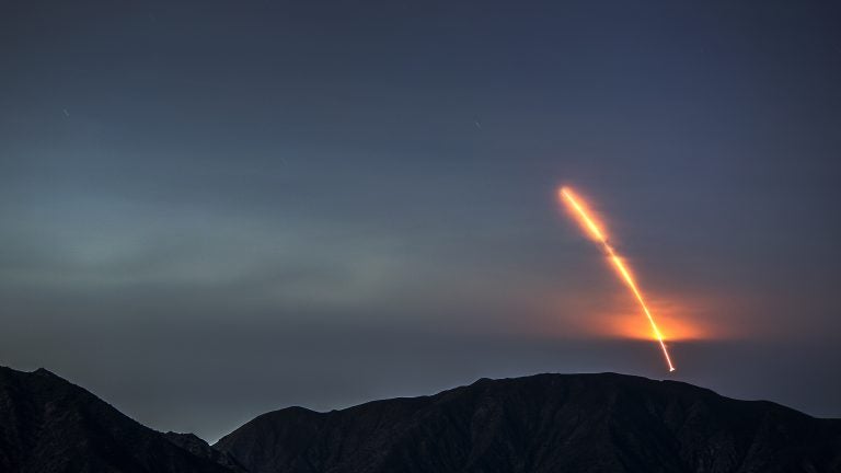The Atlas V rocket carrying the Mars InSight lander launches from Vandenberg Air Force Base, as seen from the San Gabriel Mountains more than 100 miles away, on Saturday morning. The InSight probe is the first NASA lander designed entirely to study the deep interior structure of Mars. (David McNew/Getty Images)