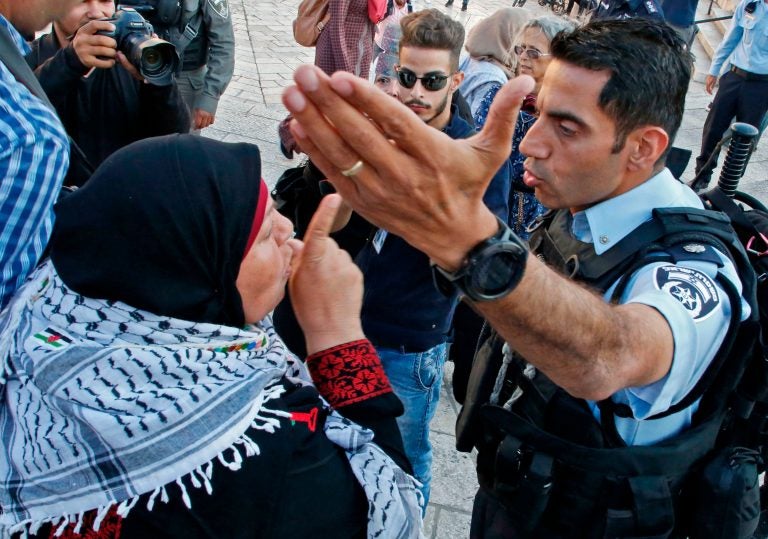 A Palestinian woman argues with a member of the Israeli security forces as they disperse a demonstration outside the Damascus Gate in the old city of Jerusalem on Tuesday. (Hazem Bader/AFP/Getty Images)