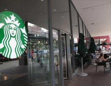 Customers sit on the patio of a Chicago Starbucks store after it was closed on May 29.