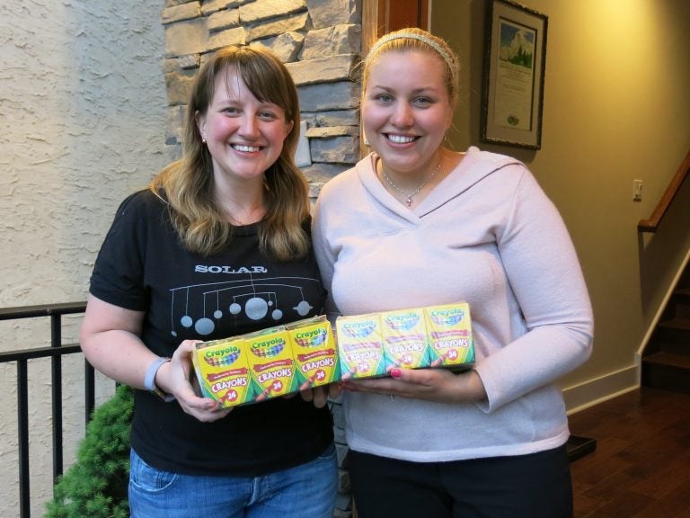 Johanna Humphrey, (left), ended up with 24 boxes of crayons she didn't need. She gave them to teacher Laura Smith, (right), through the Buy Nothing Project. It encourages people to share without money changing hands.
(Jeff Brady/NPR)
