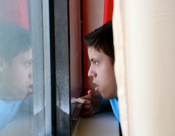 Luis Angel Chaparro Crespo, 16, watches the trains go by from the window of his apartment on the sixth floor of the Harrison Homes in North Philadelphia.