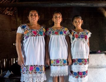 Maria de los Angeles Tun Burgos with daughters Angela, 12, and Gelmy, 9, in their family home in a Maya village in Yucatan, Mexico. (Adriana Zehbrauskas for NPR)