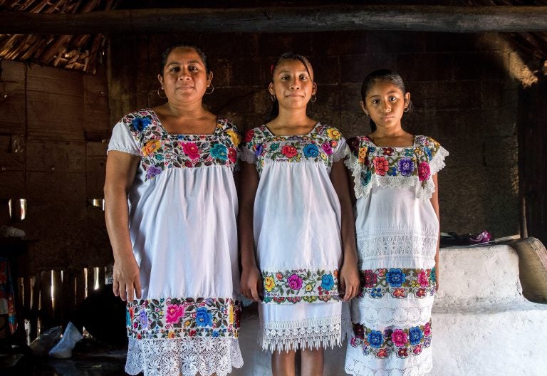 Maria de los Angeles Tun Burgos with daughters Angela, 12, and Gelmy, 9, in their family home in a Maya village in Yucatan, Mexico. (Adriana Zehbrauskas for NPR)