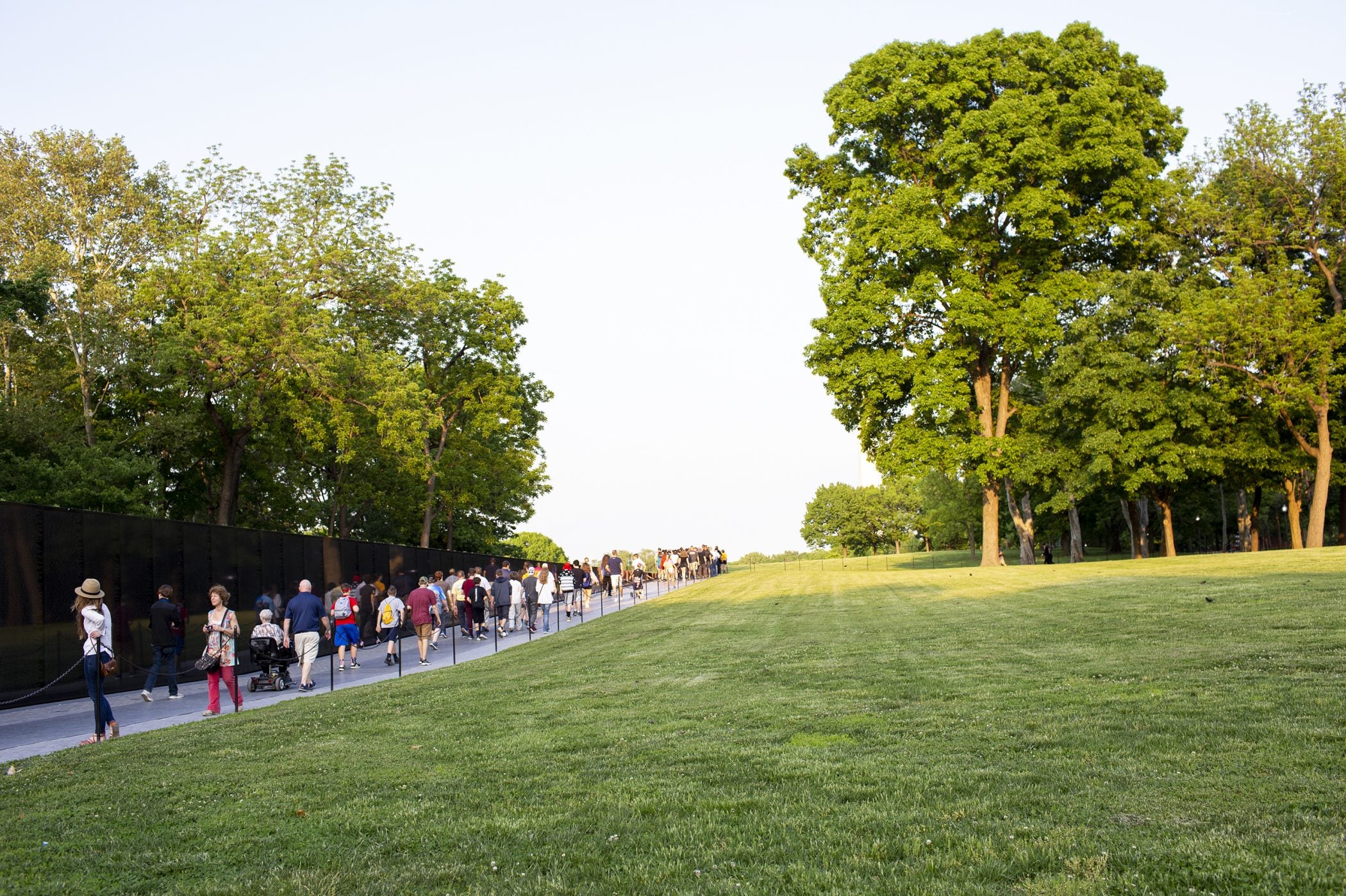 Visitors walk along the Vietnam Veterans Memorial. A new sign warns visitors that human remains left there will not be added to the memorial's permanent collection.