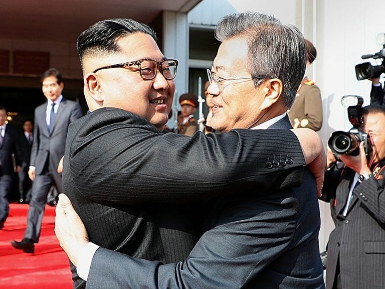 North Korean leader Kim Jong Un (left) and South Korean President Moon Jae-in embrace Saturday on the North Korean side of the shared inter-Korean area of Panmunjom. (Handout/South Korean Presidential Blue House/Getty Images)