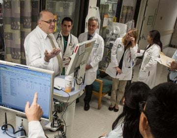 Dr. Paul Marik (left) discusses patient care with medical students and resident physicians during morning rounds at Sentara Norfolk General Hospital in 2014 in Norfolk, Va. (Jay Westcott for The Washington Post/Getty Images)