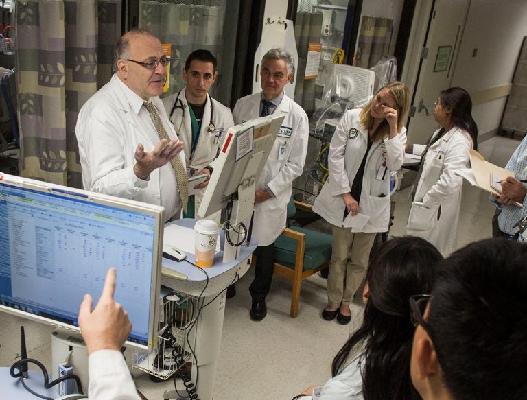 Dr. Paul Marik (left) discusses patient care with medical students and resident physicians during morning rounds at Sentara Norfolk General Hospital in 2014 in Norfolk, Va. (Jay Westcott for The Washington Post/Getty Images)