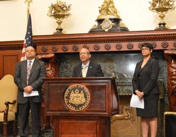 Discussing expungement measures, Pennsylvania state Rep. James Roebuck speaks Tuesday at Philadelphia City Hall along with state Reps. Morgan Cephas (right) and Angel Cruz. (Tom MacDonald/ WHYY)