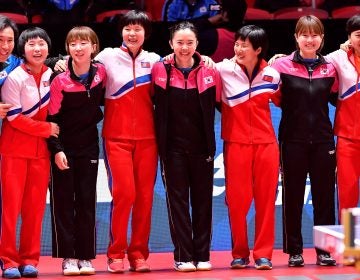 The South Korean and North Korean teams receive an ovation Thursday at the World Team Table Tennis Championships in Halmstad, Sweden. The players elected to form a unified Korean team for the tournament's semifinal round. (TT News Agency/Reuters) 