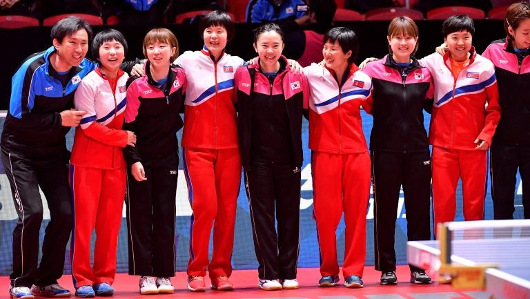 The South Korean and North Korean teams receive an ovation Thursday at the World Team Table Tennis Championships in Halmstad, Sweden. The players elected to form a unified Korean team for the tournament's semifinal round. (TT News Agency/Reuters) 