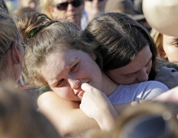 Santa Fe High School sophomore Averi Gary (center) is comforted during a vigil after the deadly mass shooting in Texas on Friday. David J. Phillip/AP