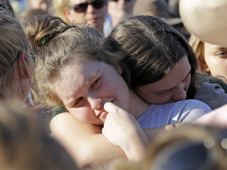 Santa Fe High School sophomore Averi Gary (center) is comforted during a vigil after the deadly mass shooting in Texas on Friday. David J. Phillip/AP