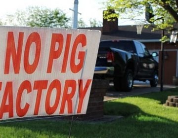 In this May 21, 2018 photo, a sign opposing an industrial hog farm is displayed at a home in Berwick, Pa. Residents who complain about foul smells from the nearby hog farm have taken their fight to the Pennsylvania Supreme Court. (Michael Rubinkam/AP Photo)