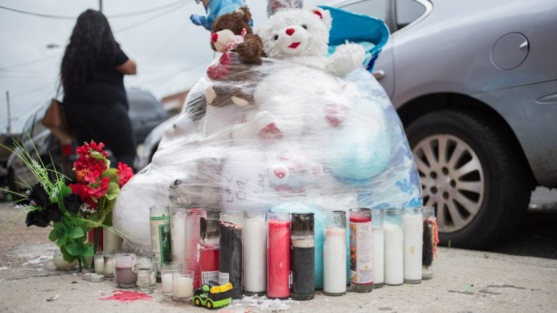 A memorial for 17-year-old Sandrea Williams sits at the corner where whe was shot and killed in outside of her mother’s West Philadelphia home. (Emily Cohen for WHYY)