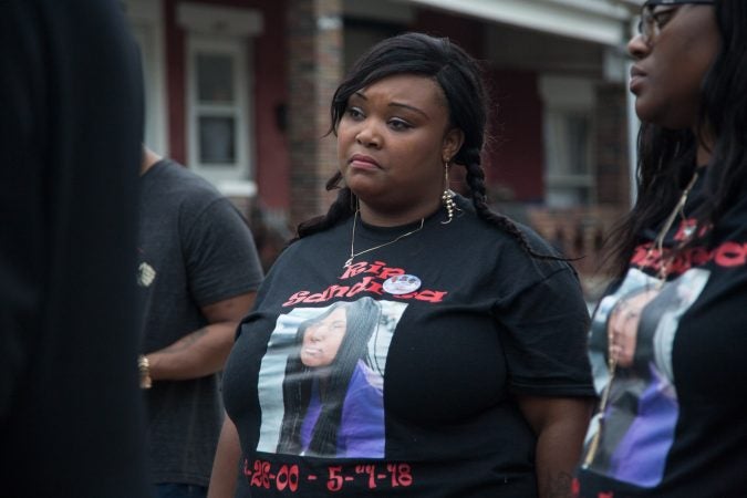 Nadia Syblis the mother of Sandrea Williams, stands solemnly as other speak at a rally to bring justice to her and her family for the death of her 17 year old daughter three weeks after she was gunned down in a random act of violence outside of her West Philadelphia home on May 11th 2018. (Emily Cohen for WHYY)