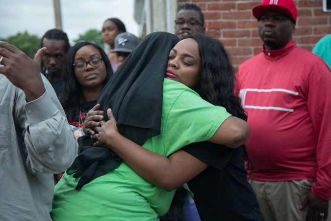 Naisha Rhoden, Sandrea’s aunt, gives a hug to Movita Johnson-Harrell, after she gave a speech to the gathered crowd about how she became an activist after her son was murdered in a drive-by act of mistaken identity. (Emily Cohen for WHYY)