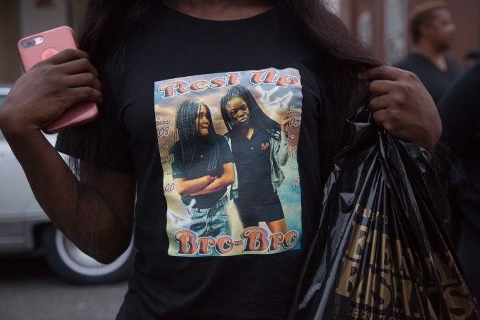 A friend displays a shirt she made in memoriam of her friend Sandrea Williams at a rally to bring justice for her death three weeks after she fell victim to gun violence in her neighborhood in West Philadelphia. (Emily Cohen for WHYY)