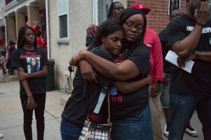 Family members of Sandrea Williams find comfort in each other at a memorial for the 17 year old who was shot in front of her mother’s home on May 11th 2018, along with two other boys. Her family, friends, and community rallied together on May 31st, 2018 in an effort to bring justice for Sandrea. (Emily Cohen for WHYY)