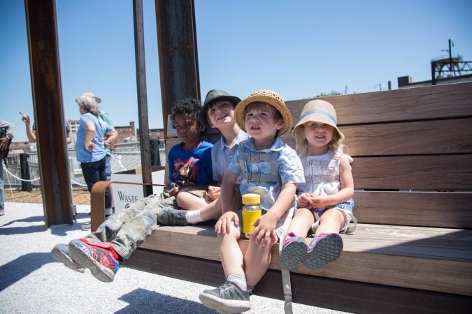 Children from the Fike and Ryan families enjoy one of the swings that have been installed in the park. (Emily Cohen for WHYY)