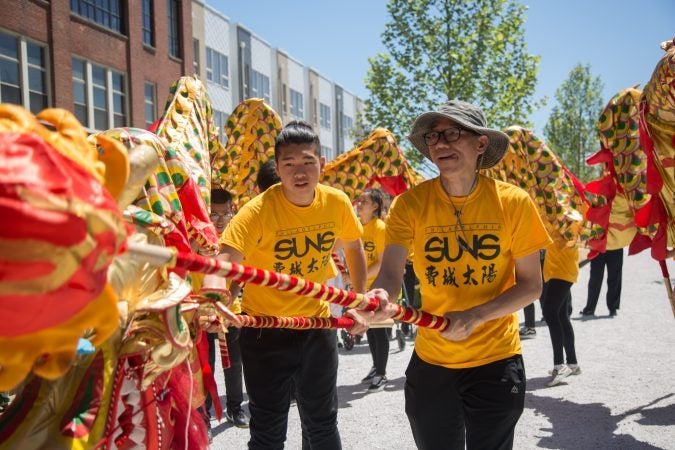 Members of the Philadelphia Suns inaugurate the rail park with a traditional lion dance June 14th 2018. (Emily Cohen for WHYY)