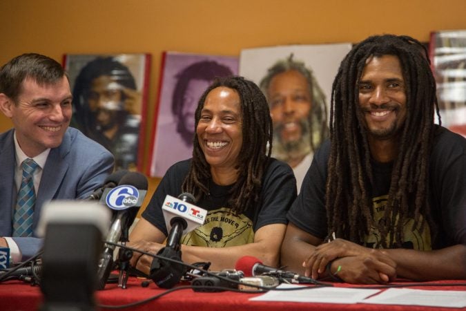 Debbie Africa sits with her lawyer, Brad Thomson (left), and her son Michael Africa Jr. (right) as she makes her first public appearance since being released from prison after 39 years and 10 months of incarceration. (Emily Cohen for WHYY)