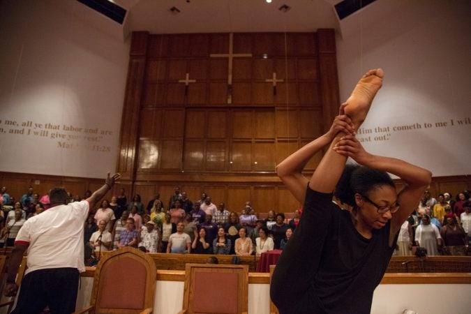 A Praise Dancer, from Mother Bethel African Methodist Church in South Philadelphia, dances to the music of the multi-community choir that gathered at Deliverance Evangelical Church in North Philadelphia on June 25 to rehearse before their gospel concert at Independence Hall as part of this year’s Wawa Welcome America celebration. (Emily Cohen for WHYY)