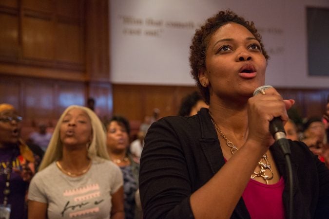 Maria Caldwell, from Pentecostal Experience, sings in a duet with members of a multi-community choir sing her chorus. More than 100 faith singers from across Philadelphia gather at Deliverance Evangelical Church in North Philadelphia on June 25 to rehearse for their gospel concert at Independence Hall as part of this year’s Wawa Welcome America celebration. (Emily Cohen for WHYY)