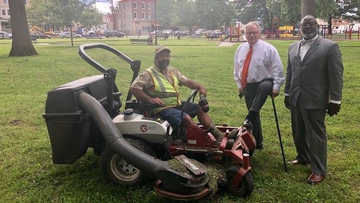 Scott Wagner in Malcolm X Park post-cleanup, accompanied by a contractor, supporter and lawnmower. (Photo by Wagner Campaign)