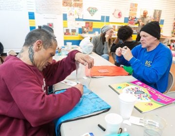 Kenan Nameli (left) and other workshop participants at the Kensington Storefront. Nameli lives in a nearby abandoned building, struggles with addiction, and said he has tried to enter into recovery a number of times. (Steve Weinik/Mural Arts)