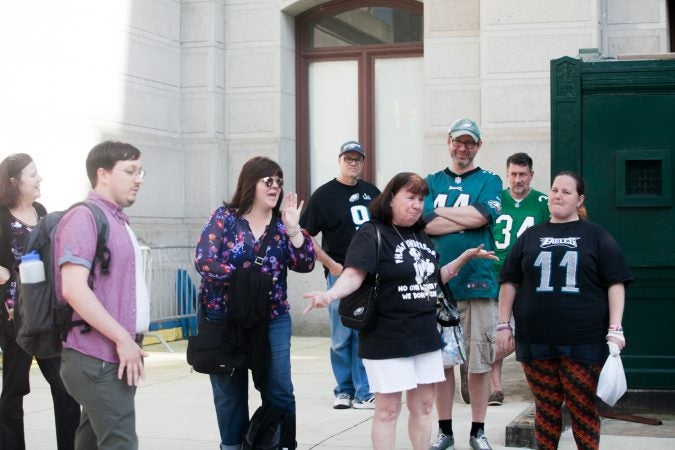 Eagles fans sing the team's fight song at a rally for the team at City Hall Tuesday evening a day after President Trump canceled an event at the White House to honor the Super Bowl Champions. (Brad Larrison for WHYY)