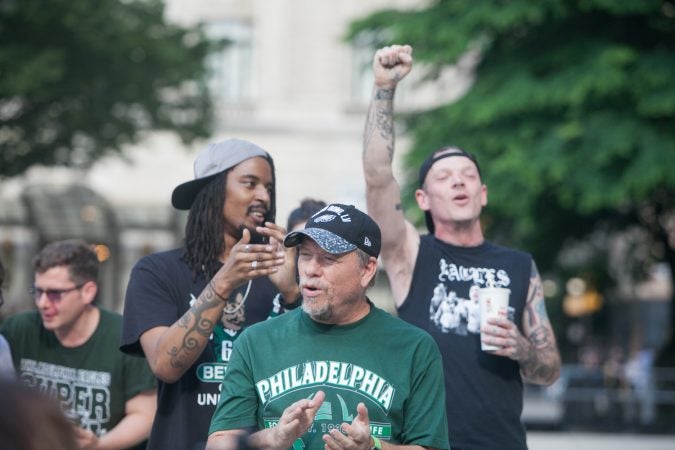 Eagles fans sing the team's fight song at a rally for the team at City Hall Tuesday evening a day after President Trump canceled an event at the White House to honor the Super Bowl Champions. (Brad Larrison for WHYY)