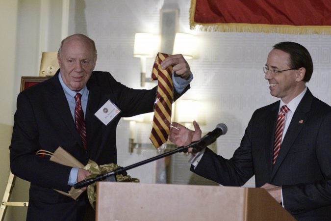 Deputy Attorney General Rod Rosenstein receives a crimson-yellow tie from his father, Central High alumni Robert Rosensten, during the annual alumni dinner at Central High School, Tuesday evening in Phildelphia. (Bastiaan Slabbers for WHYY)