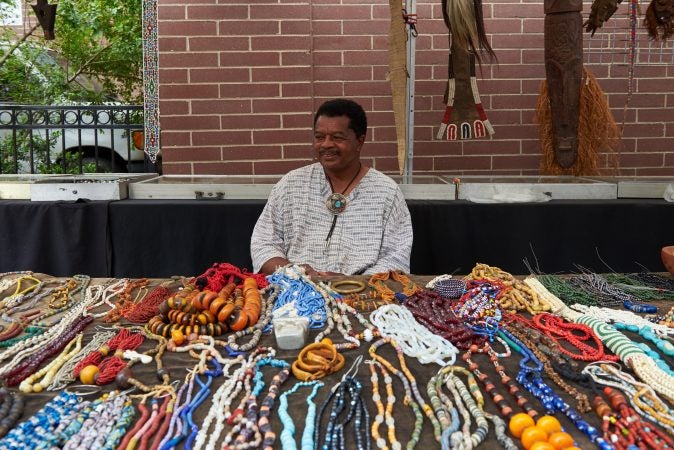 Otis Williams of Philadelphia sells African jewelry and figurines at the 2018 Odunde Festival in Philadelphia. He has been a vendor at the festival for roughly 30 years. (Natalie Piserchio for WHYY News) 