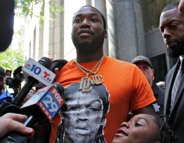Meek Mill leaves the Criminal Justice Center with his attorneys after asking a judge to throw out a 10-year-old conviction on gun and drug charges. (Emma Lee/WHYY)