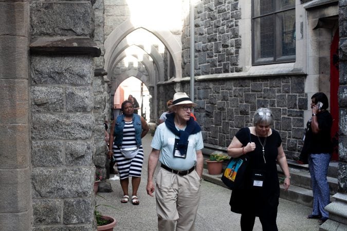 Guests gathered in the courtyard of the Church of The Advocate in North Philadelphia before Finding Sanctuary. (Brad Larrison for WHYY)