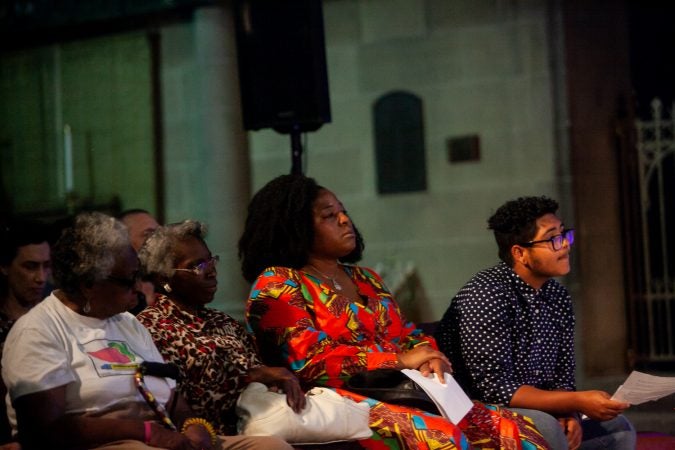 Guests listen to stories at the Finding Sanctuary storytelling event at Church of the Advocate in North Philadelphia. (Brad Larrison for WHYY)
