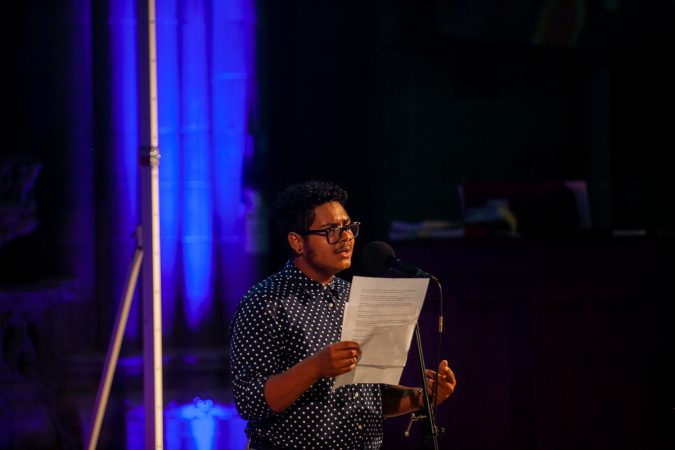 Corem Coreano, a multidisciplinary artist, shares a story at Finding Sannctuary at Church of the Advocate in North Philadelphia. (Brad Larrison for WHYY)