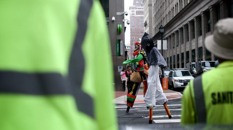 Marchers on stilts make their way through Center City during the annual Juneteenth parade on Saturday. (Bastiaan Slabbers for WHYY)